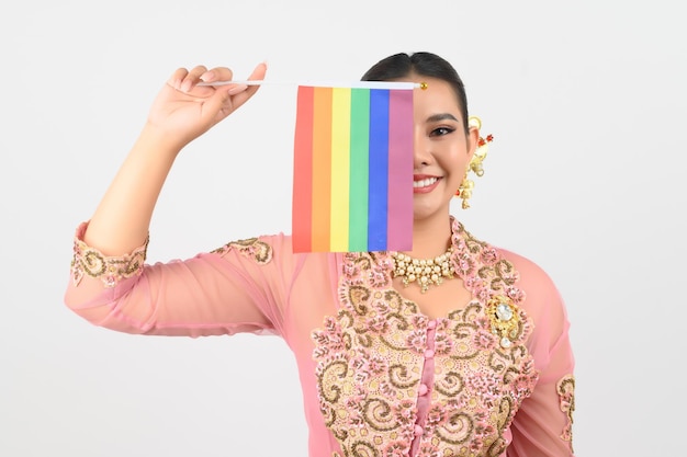 Free photo young beautiful woman dress up in local culture in southern region with rainbow flag