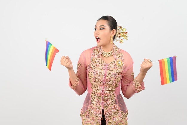 Free photo young beautiful woman dress up in local culture in southern region with rainbow flag