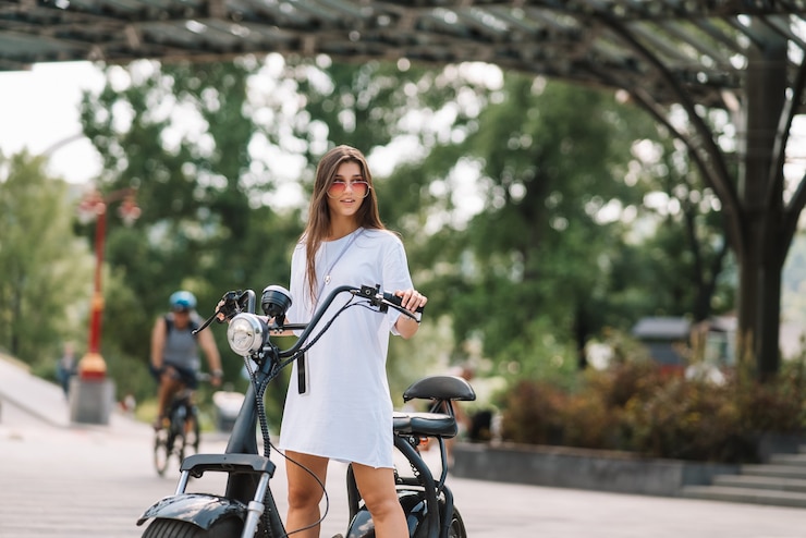 Free Photo young beautiful woman and an electric scooter