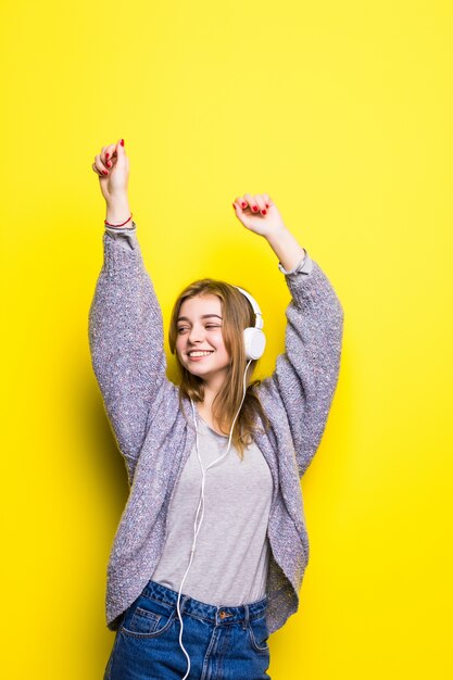 Young beautiful woman enjoying with listening the music in headphones