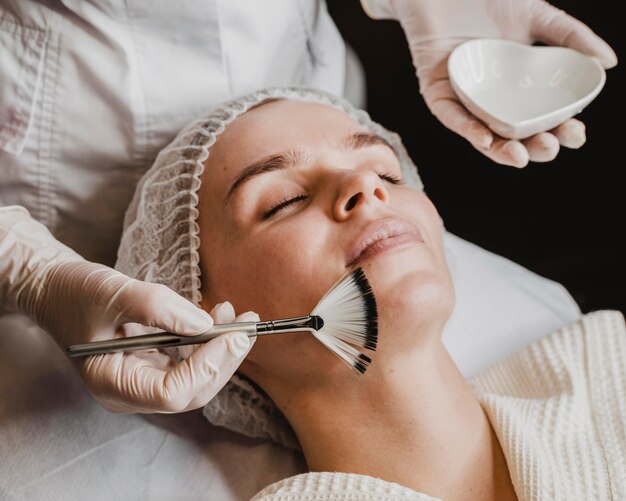 Young beautiful woman getting a face skin treatment at the spa