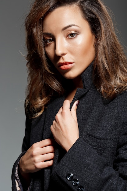 Young beautiful woman  over grey wall