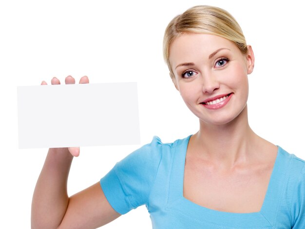 Young beautiful  woman holding the blank business card near her face - on a white