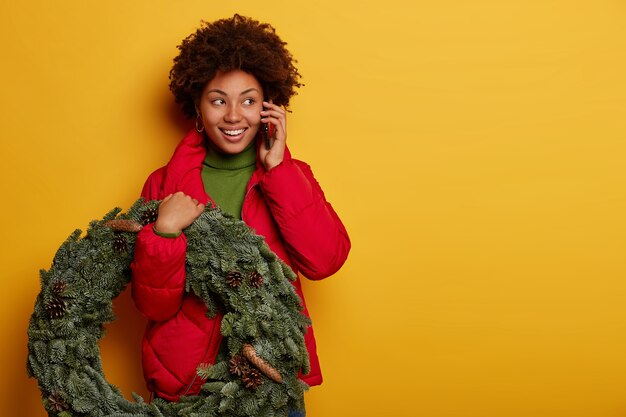 Young beautiful woman holding Christmas decorations