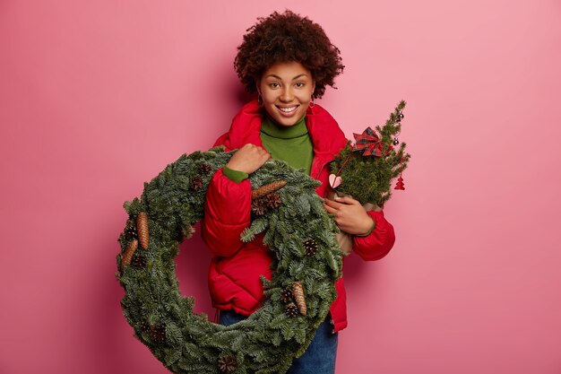 Young beautiful woman holding Christmas decorations