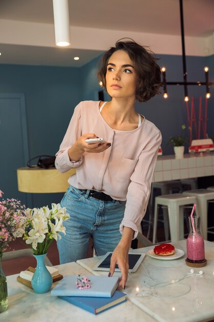 Young beautiful woman holding mobile phone