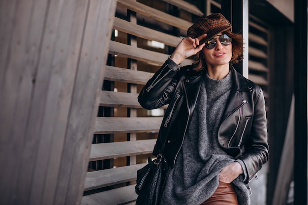 Young beautiful woman in leather jacket outside the street