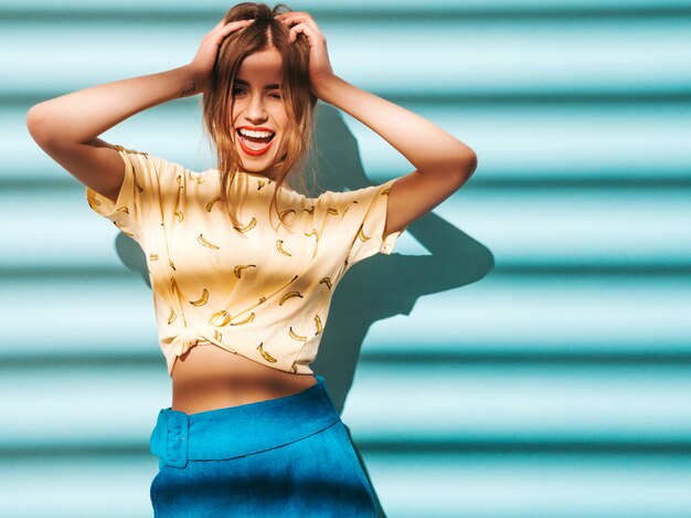 Young beautiful woman looking . Trendy girl in casual summer yellow T-shirt clothes.