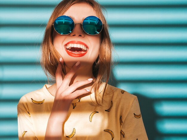 Young beautiful woman looking . Trendy girl in casual summer yellow T-shirt clothes. 