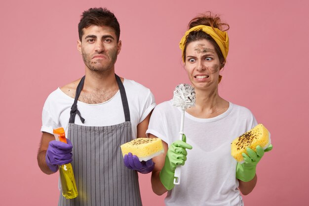 Young beautiful woman looking with disgust at dirty brush