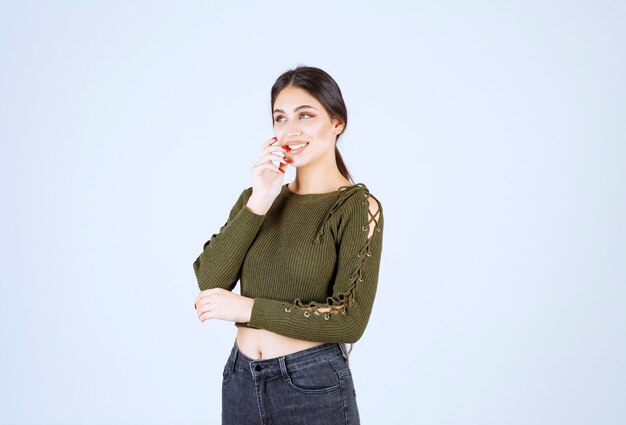 A young beautiful woman model in green blouse feeling happy