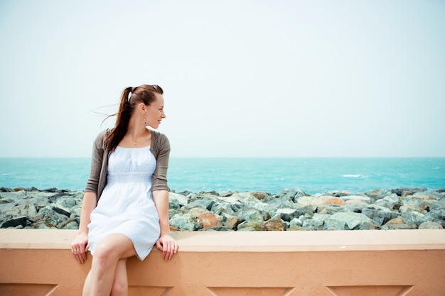 Young beautiful woman posing on the beach