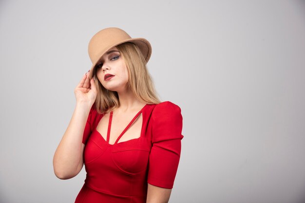 Young beautiful woman posing with hat.