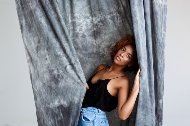 Free photo young beautiful woman posing, wrapping up  in grey cloth