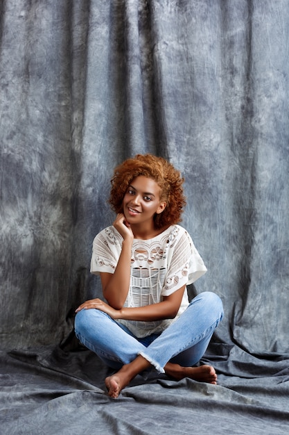 Young beautiful woman sitting at floor