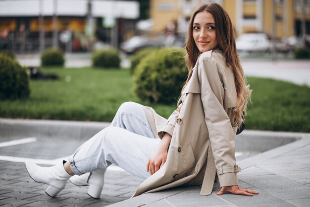 Young beautiful woman sitting in park