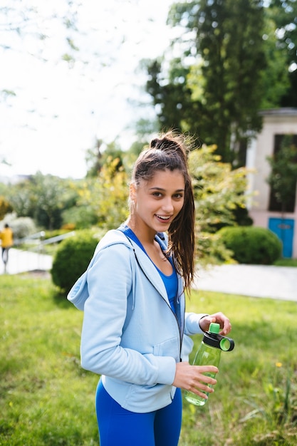 Young beautiful woman in a sporting suit after a workout in yoga