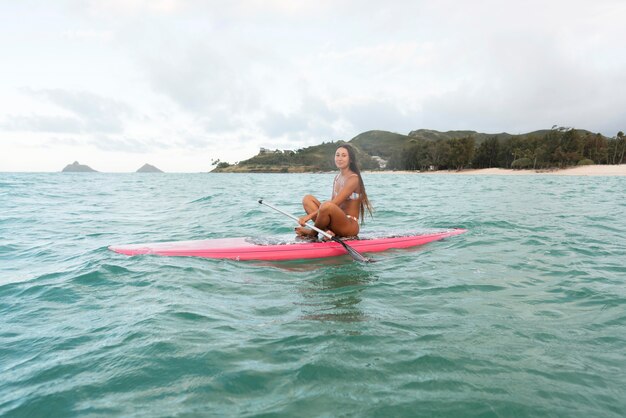 Young beautiful woman surfing in hawaii