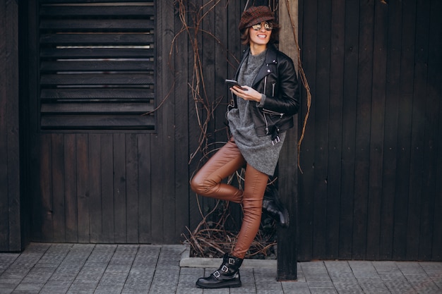 Young beautiful woman talking on the phone outside