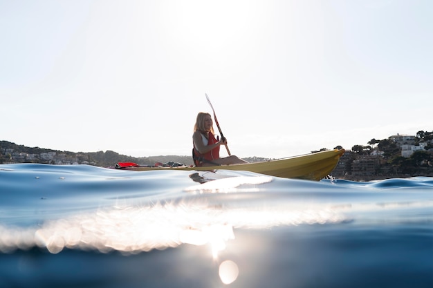 Young beautiful woman traveling by canoe