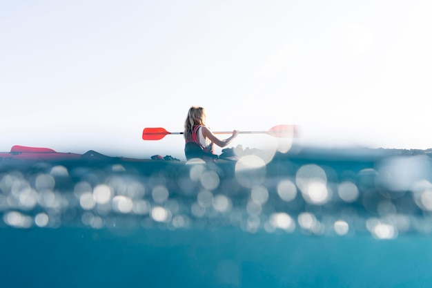 Young beautiful woman traveling by canoe