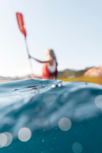 Free photo young beautiful woman traveling by canoe