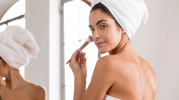 Young beautiful woman using a make-up brush