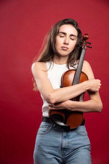 Young beautiful woman violin player 