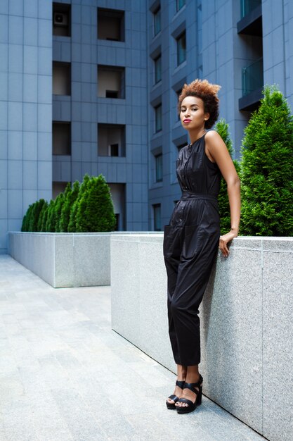 Young beautiful woman walking down city