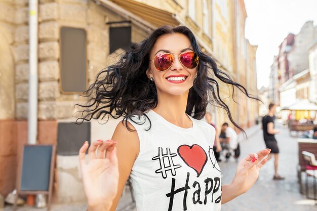 Young beautiful woman walking in old city street