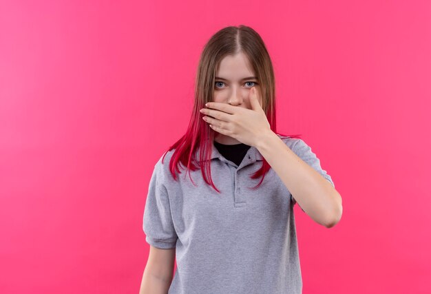  young beautiful woman wearing gray t-shirt covered mouth with hand on isolated pink wall