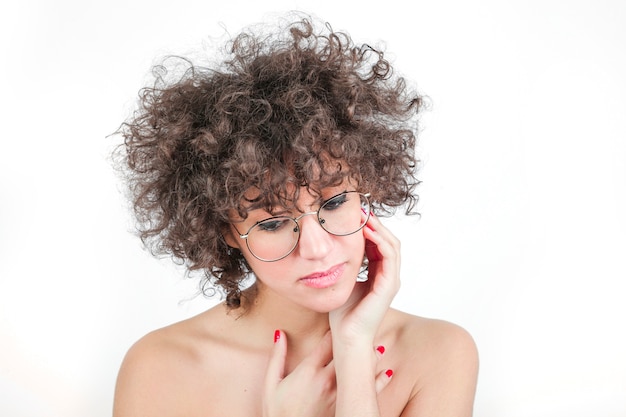 Young beautiful woman wearing spectacles against white background
