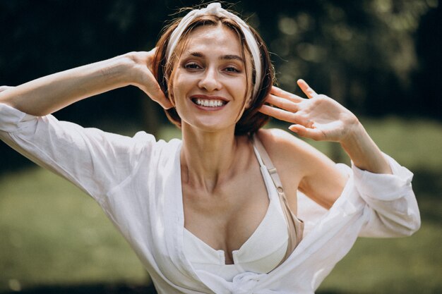 Young beautiful woman in white shirt in the back yard