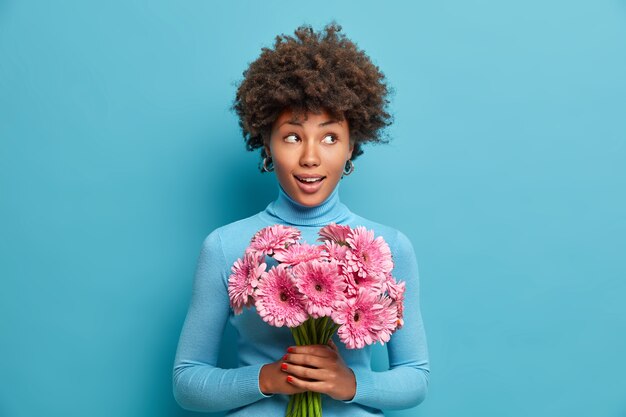 Young beautiful woman with curly hair isolated