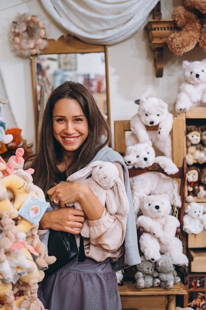 Young beautiful woman with little plush rabbit