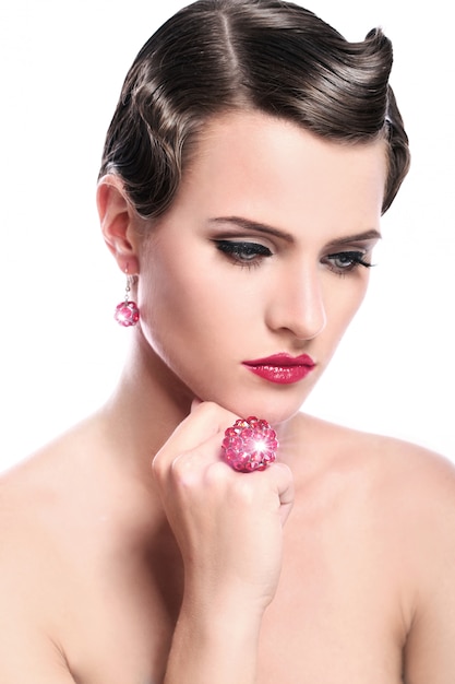 Young and beautiful woman with red jewelry
