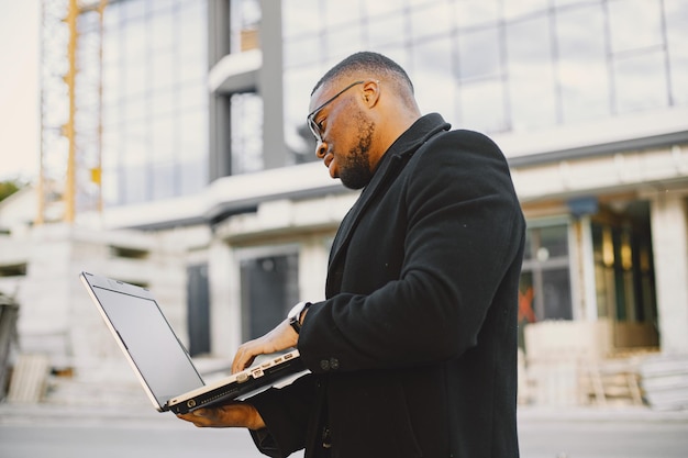 Young black businessman working with laptop