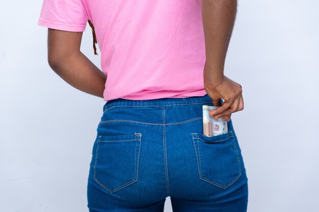 Young black lady puts some monet into her back pocket.