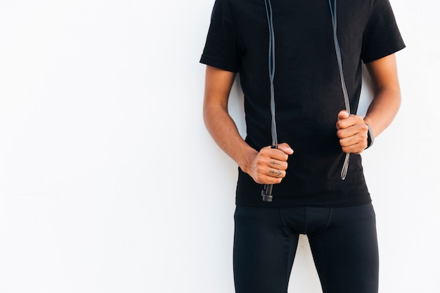 Young black man in black with jump rope