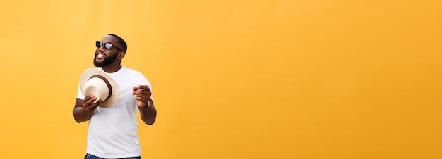 Young black man top dancing isolated on a yellow background