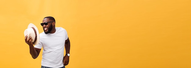 Free photo young black man top dancing isolated on a yellow background