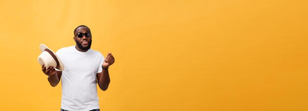 Young black man top dancing isolated on a yellow background