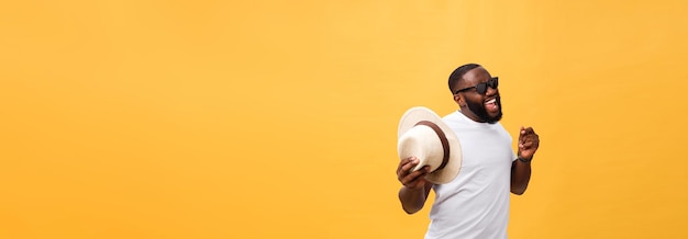 Young black man top dancing isolated on a yellow background