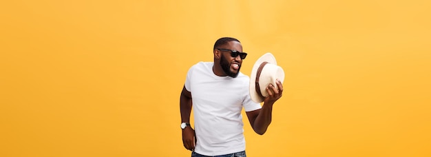 Young black man top dancing isolated on a yellow background