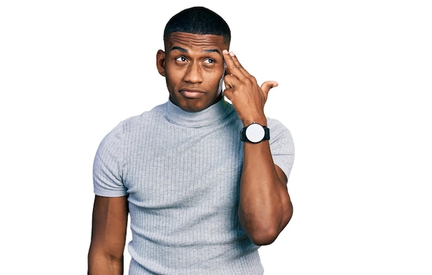 Free photo young black man wearing casual t shirt shooting and killing oneself pointing hand and fingers to head like gun, suicide gesture.