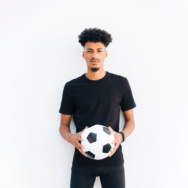 Young black man with ball looking at camera