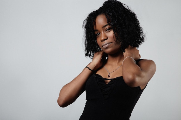 Young black mixed race woman with short curly hair stuido portrit