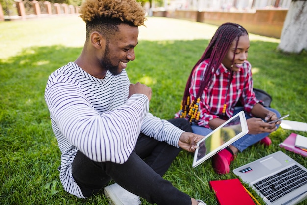 Young black people studying in park