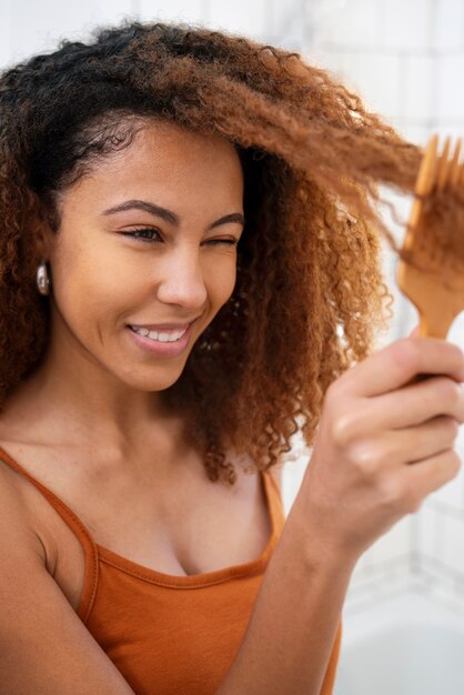 Young black person taking care of afro hair