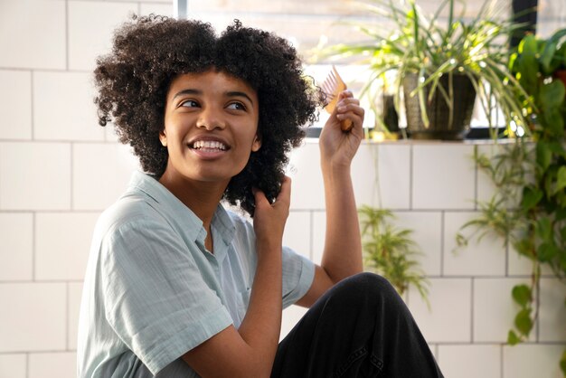 Young black person taking care of afro hair